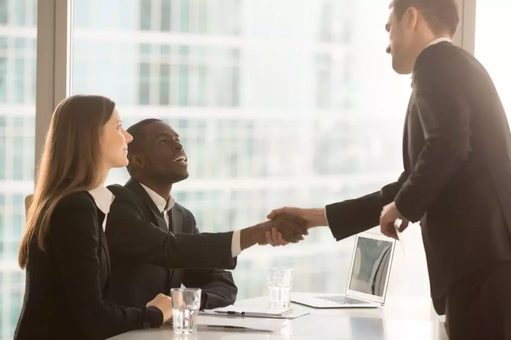 businessman greeting potential candidate for an interview